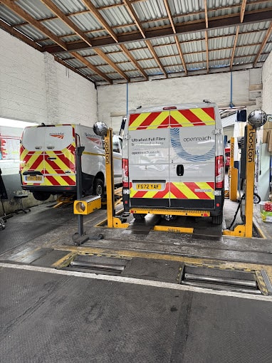 An Openreach and Network Rail vans side by side on ramps. 