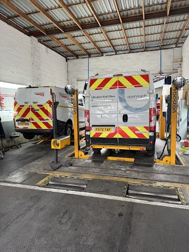 An Openreach and Network Rail vans side by side on ramps. 