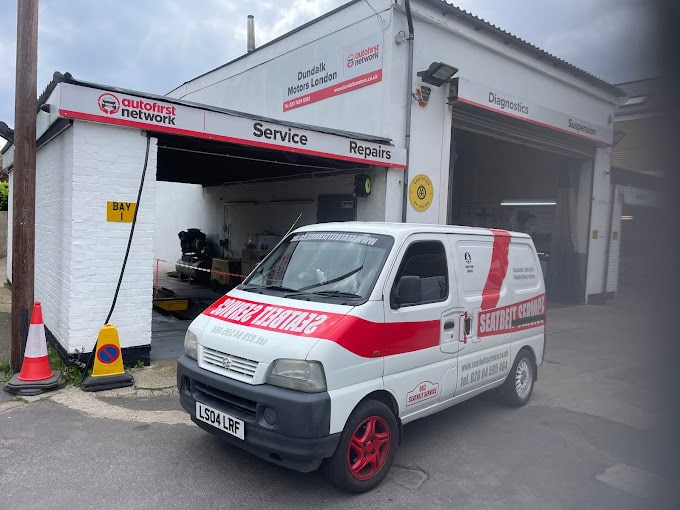 A small white van outside the garage facilities.